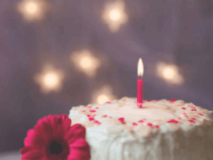 GIF: Purple birthday cake slice with candles