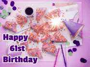 Happy Birthday Age 61 GIF, 61st Birthday GIF: A big paper sparkle highlights this animated birthday gif showing a birthday cake place setting with decorations.