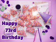 Happy Birthday Age 73 GIF, 73rd Birthday GIF: A big paper sparkle highlights this animated birthday gif showing a birthday cake place setting with decorations.