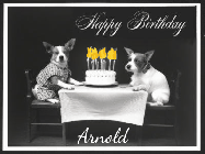 Happy Birthday Arnold GIF: Vintage animated birthday card gif with name, flickering candles, birthday cake, and 2 dogs sitting at the table.