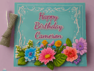 Happy Birthday Cameron GIF: Animated Birthday GIF as a colorful birthday card reading Happy Birthday Name and flower petals floating past.