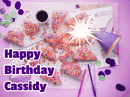 Happy Birthday Cassidy GIF: A big paper sparkle highlights this animated birthday gif showing a birthday cake place setting with decorations.