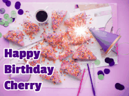 Happy Birthday Cherry GIF: A big paper sparkle highlights this animated birthday gif showing a birthday cake place setting with decorations.