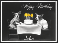 Happy Birthday Jake GIF: Vintage animated birthday card gif with name, flickering candles, birthday cake, and 2 dogs sitting at the table.