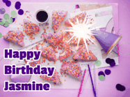 Happy Birthday Jasmine GIF: A big paper sparkle highlights this animated birthday gif showing a birthday cake place setting with decorations.