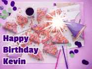 Happy Birthday Kevin GIF: A big paper sparkle highlights this animated birthday gif showing a birthday cake place setting with decorations.