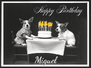 Happy Birthday Miguel GIF: Vintage animated birthday card gif with name, flickering candles, birthday cake, and 2 dogs sitting at the table.