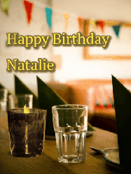 Happy Birthday Natalie GIF: Beautiful flower birthday gif of a cute bird visiting a birthday message with animated musical notes and a name you customize.