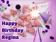 Happy Birthday Regina GIF: A big paper sparkle highlights this animated birthday gif showing a birthday cake place setting with decorations.