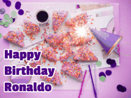 Happy Birthday Ronaldo GIF: A big paper sparkle highlights this animated birthday gif showing a birthday cake place setting with decorations.