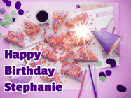 Happy Birthday Stephanie GIF: A big paper sparkle highlights this animated birthday gif showing a birthday cake place setting with decorations.
