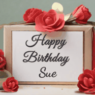 Happy Birthday Sue GIF: An elegant gift box label animated gif with glitter flowing over the label and a name appearing that you can customize. The scene is decorated with roses
