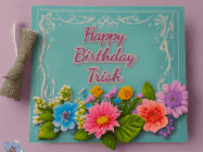 Happy Birthday Trish GIF: Animated Birthday GIF as a colorful birthday card reading Happy Birthday Name and flower petals floating past.