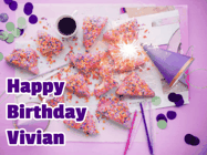 Happy Birthday Vivian GIF: A big paper sparkle highlights this animated birthday gif showing a birthday cake place setting with decorations.