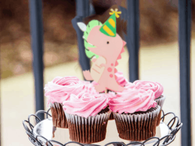 Happy birthday cupcakes gif of a cut-out dinosaur running on the frosting. Its weird. Customize the name and text.